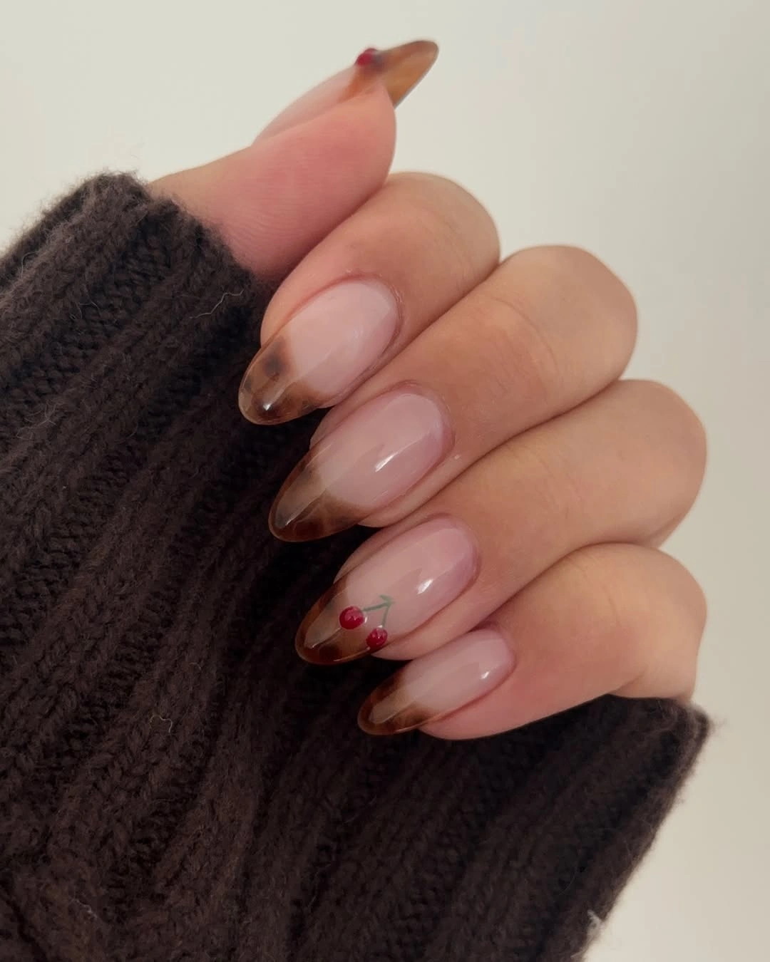 Sheer nude almond nails with translucent brown tips