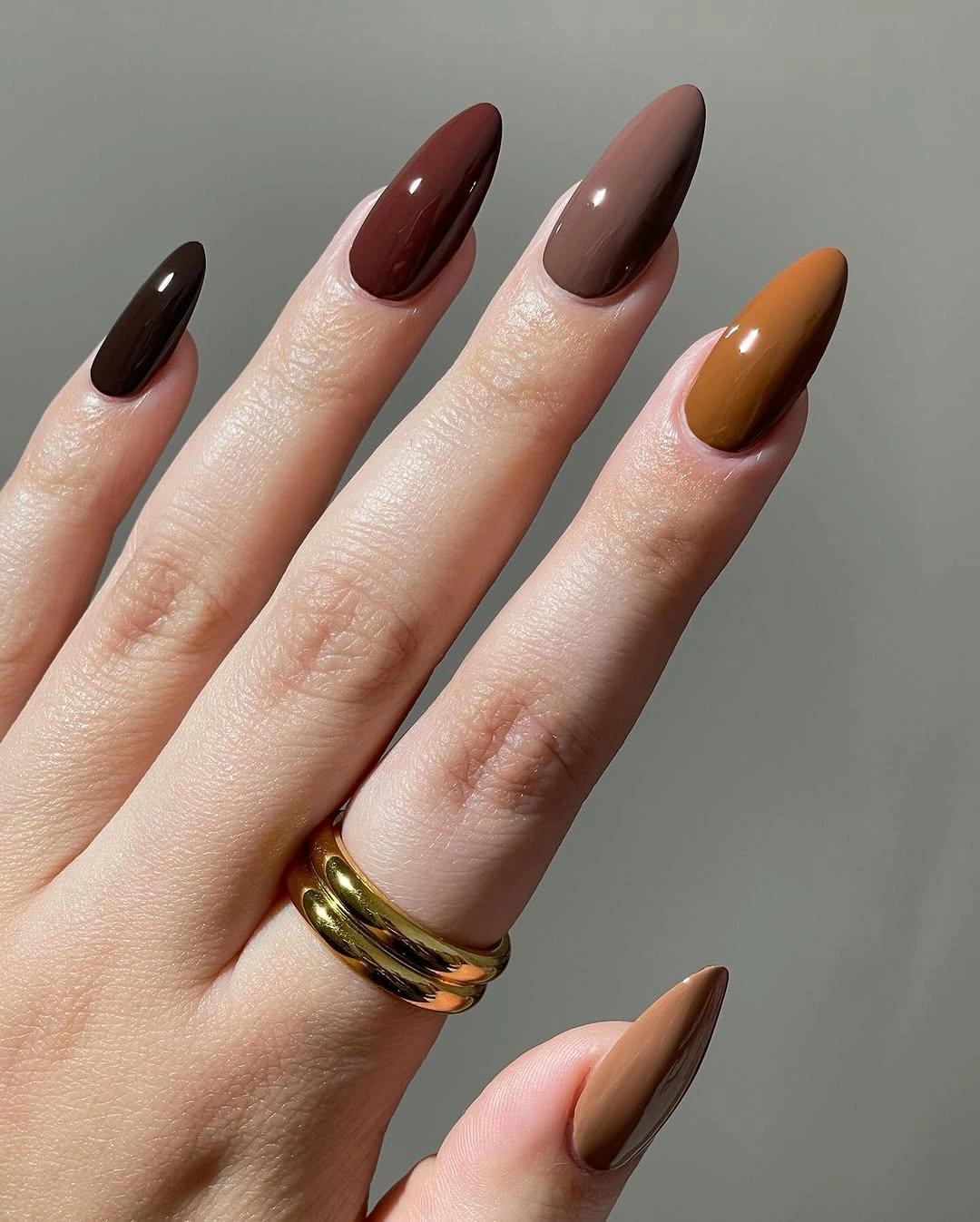 Long almond nails in burgundy black brown and one amber accent