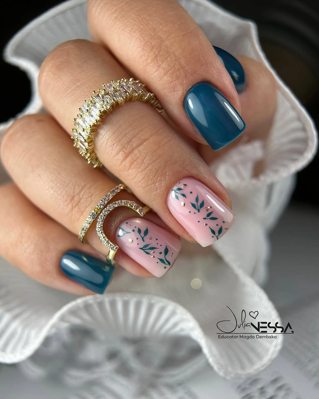 Medium almond nails with navy solids and pale abstract accents