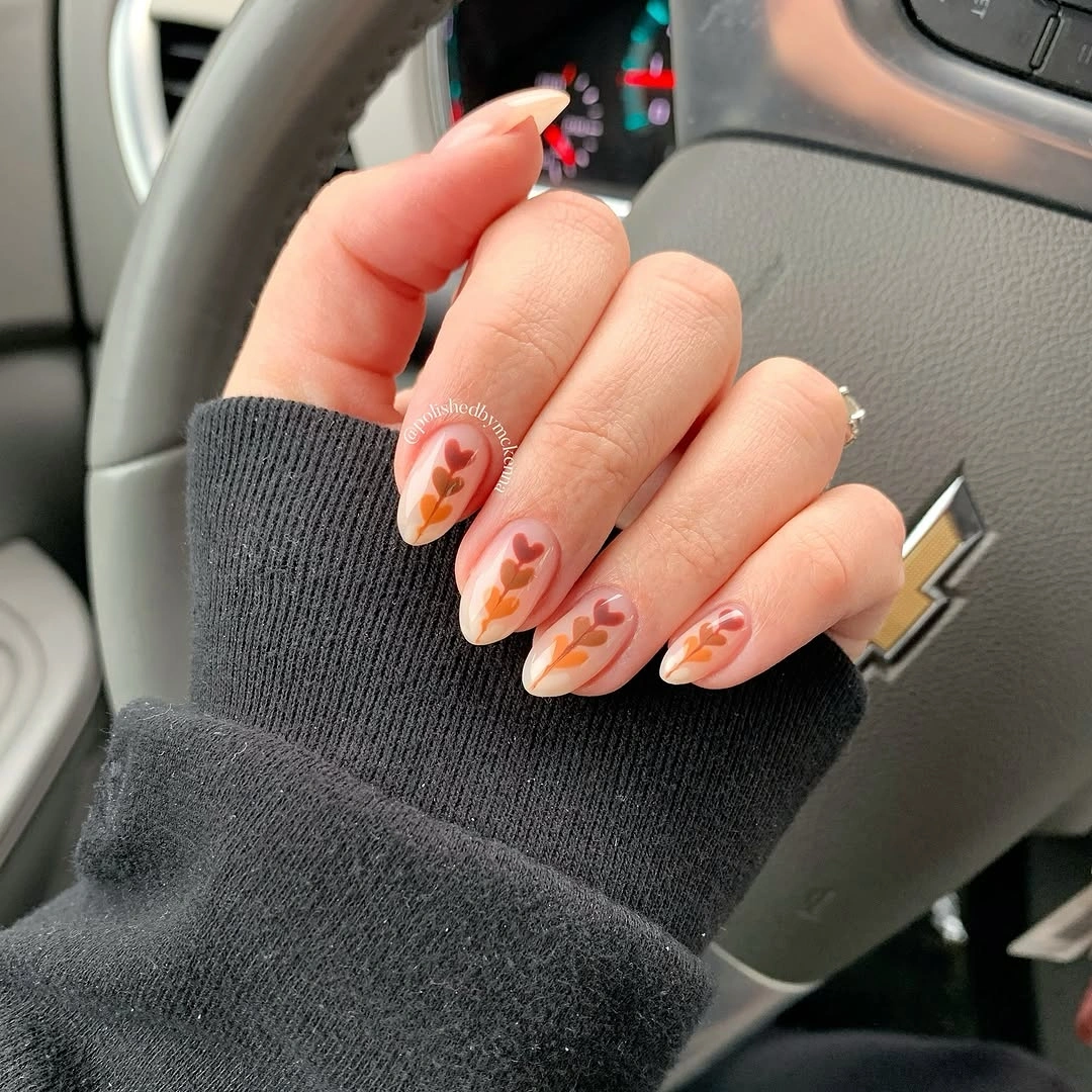 Short almond nails with peach coral and soft floral accents