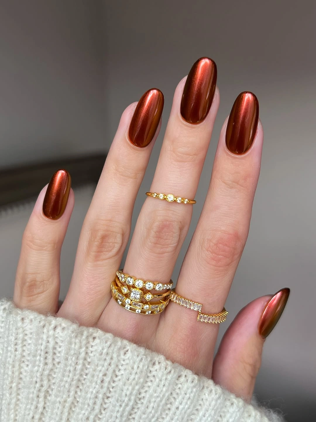 Long almond nails in copper rose metallic with a small accent