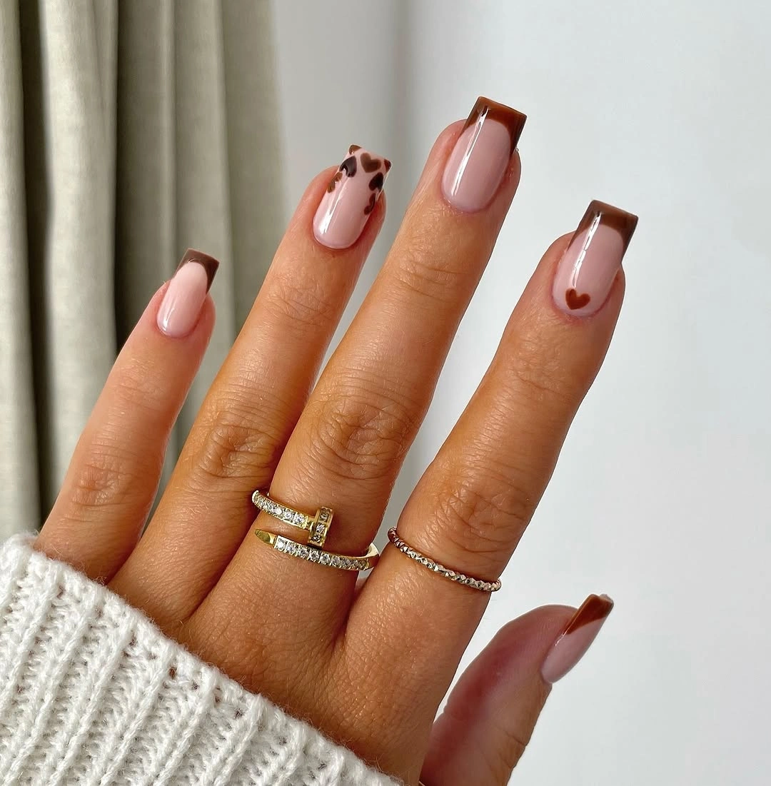 Medium square nails with brown French tips and coral accents