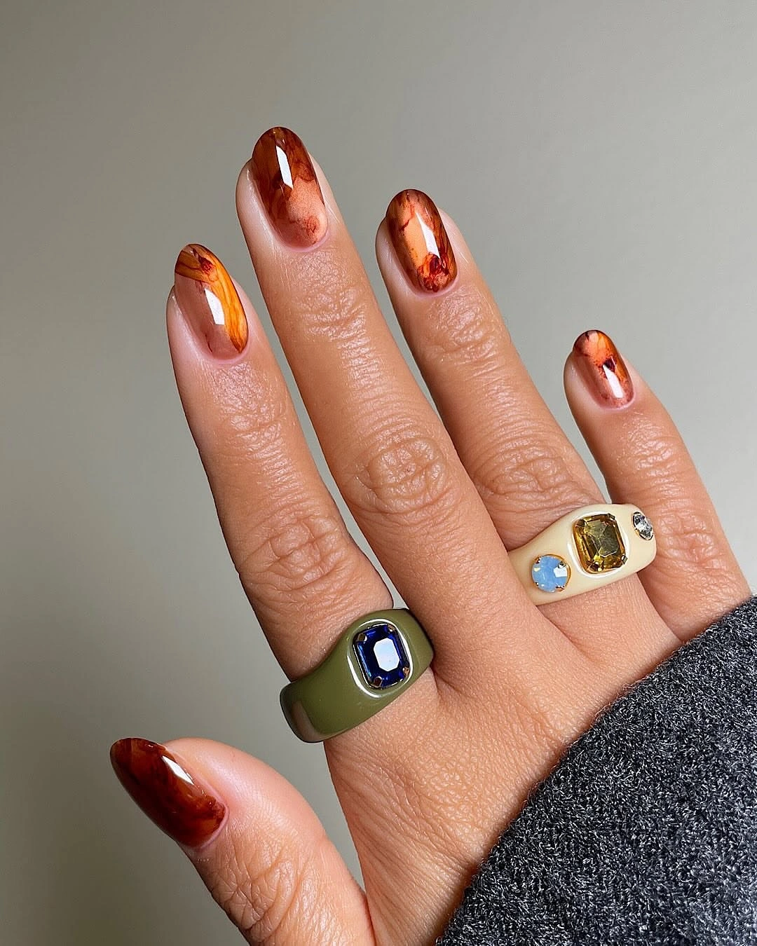Medium almond nails with reflective copper and warm brown accents