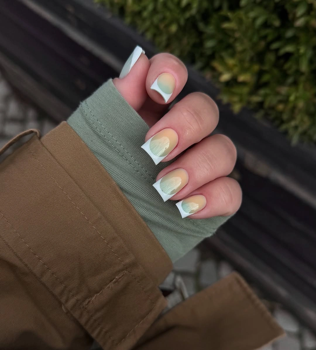 Short square nails with pale pink bases and pastel color patches