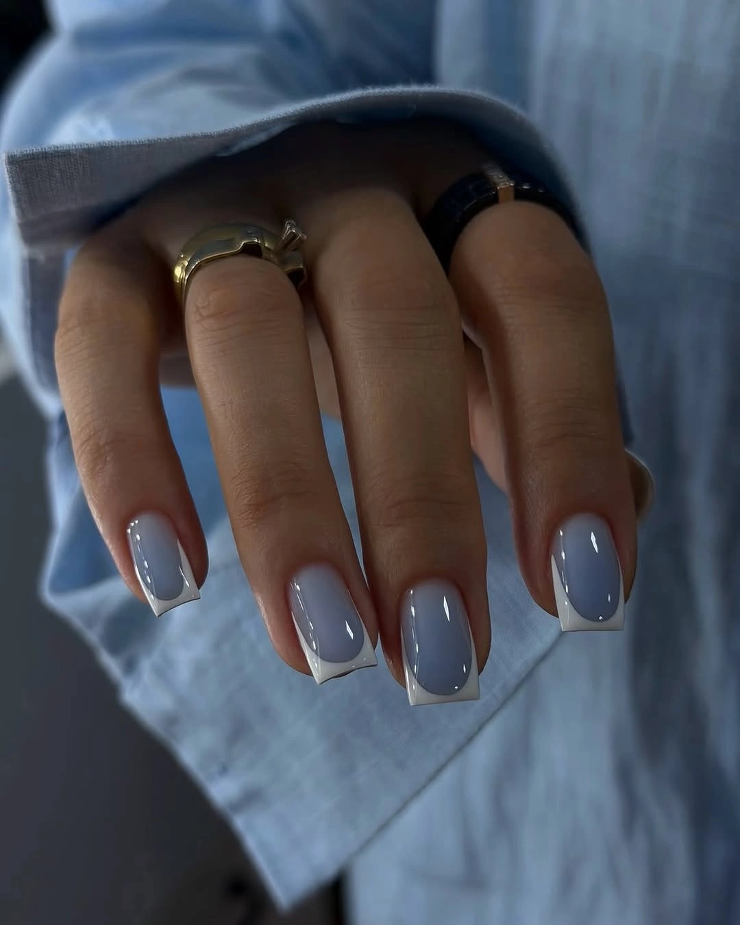 Short square nails in a muted glossy slate blue gray color
