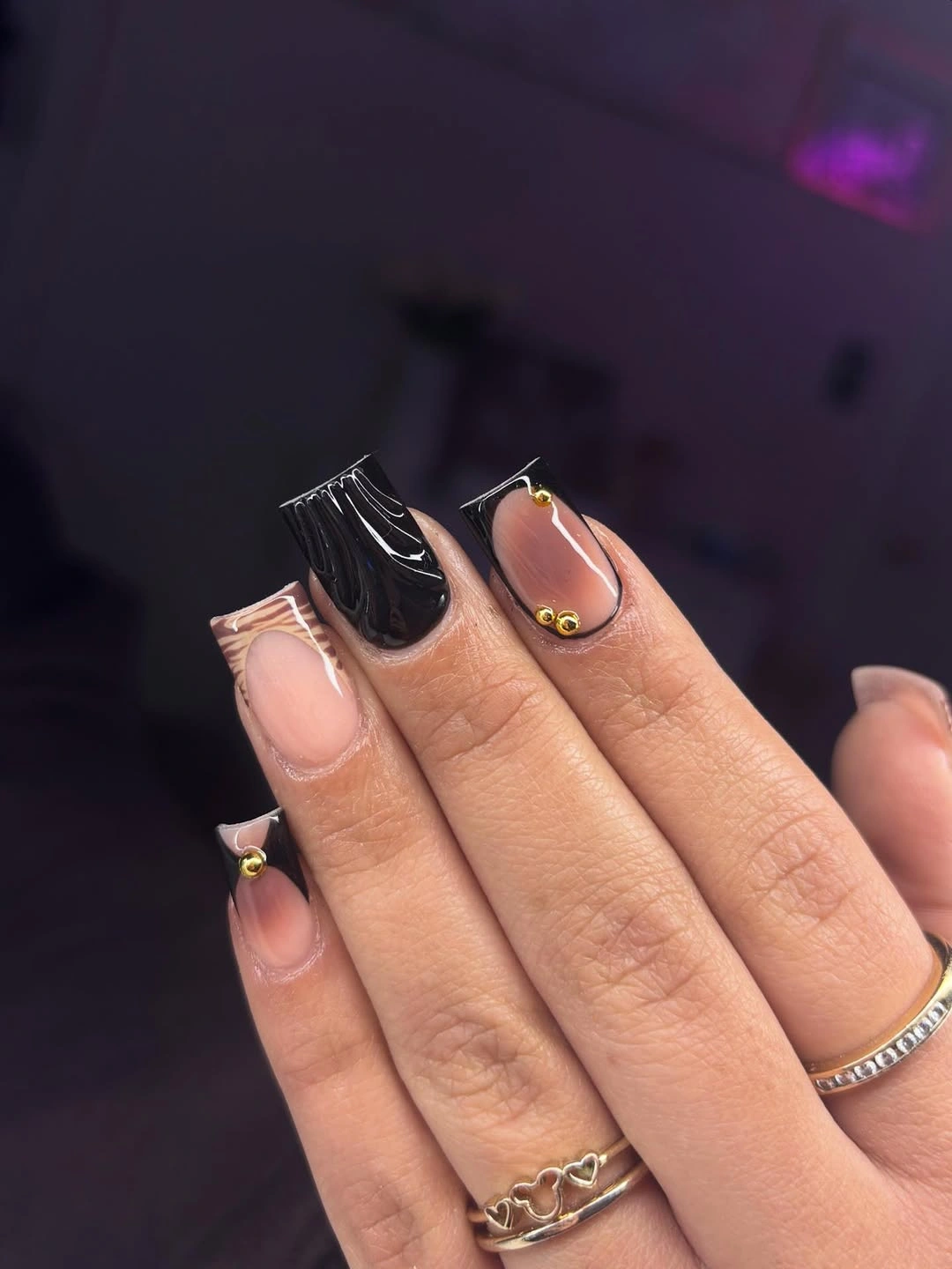 Long square nails mixing black pale negative space and tiny gold accents