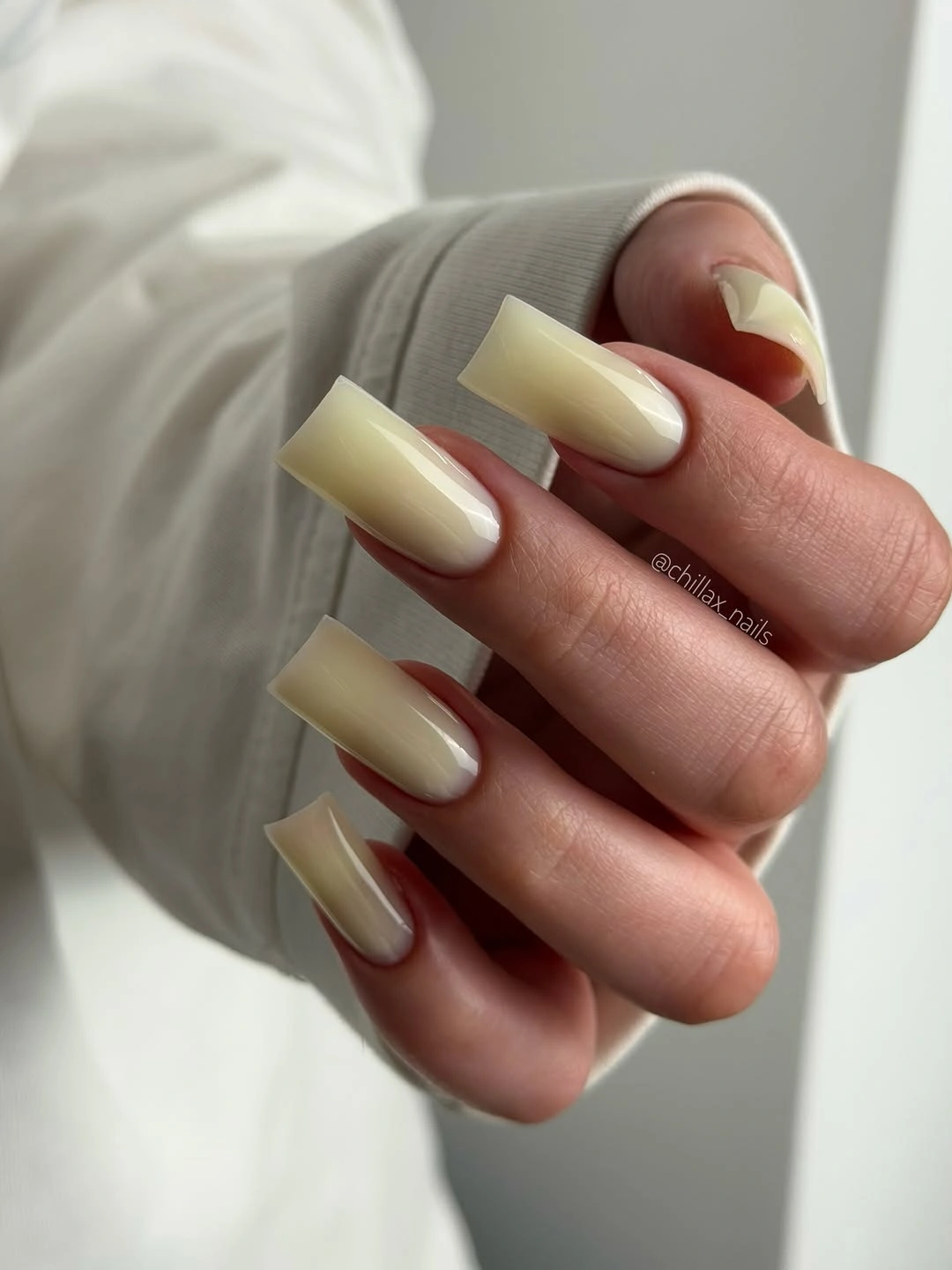 Medium square nails in a glossy creamy pale yellow shade
