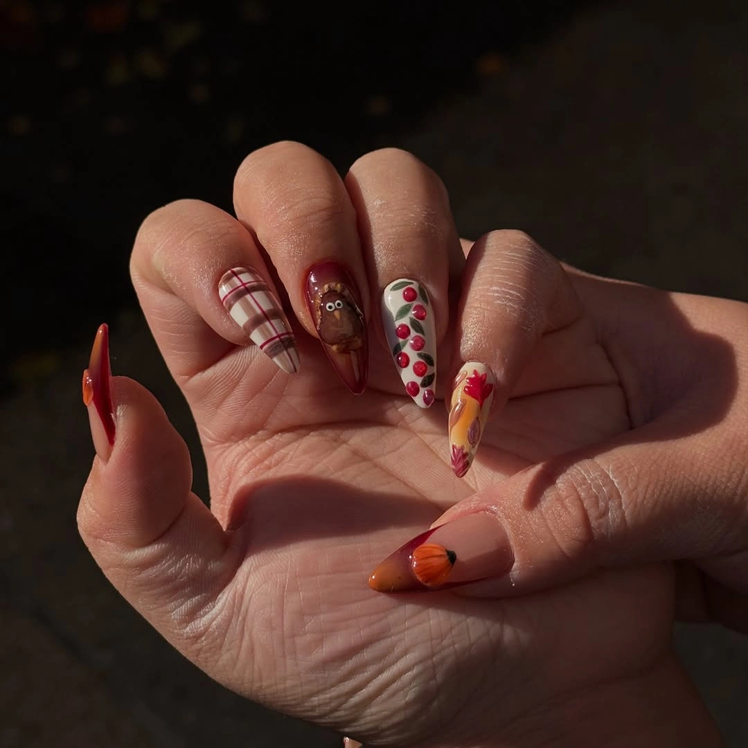 Burgundy almond nails with warm stripes flowers and orange accents