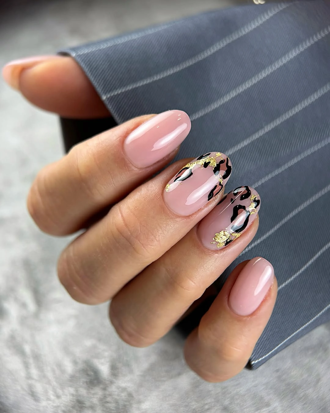 Blush pink almond nails with warm tortoise accent details