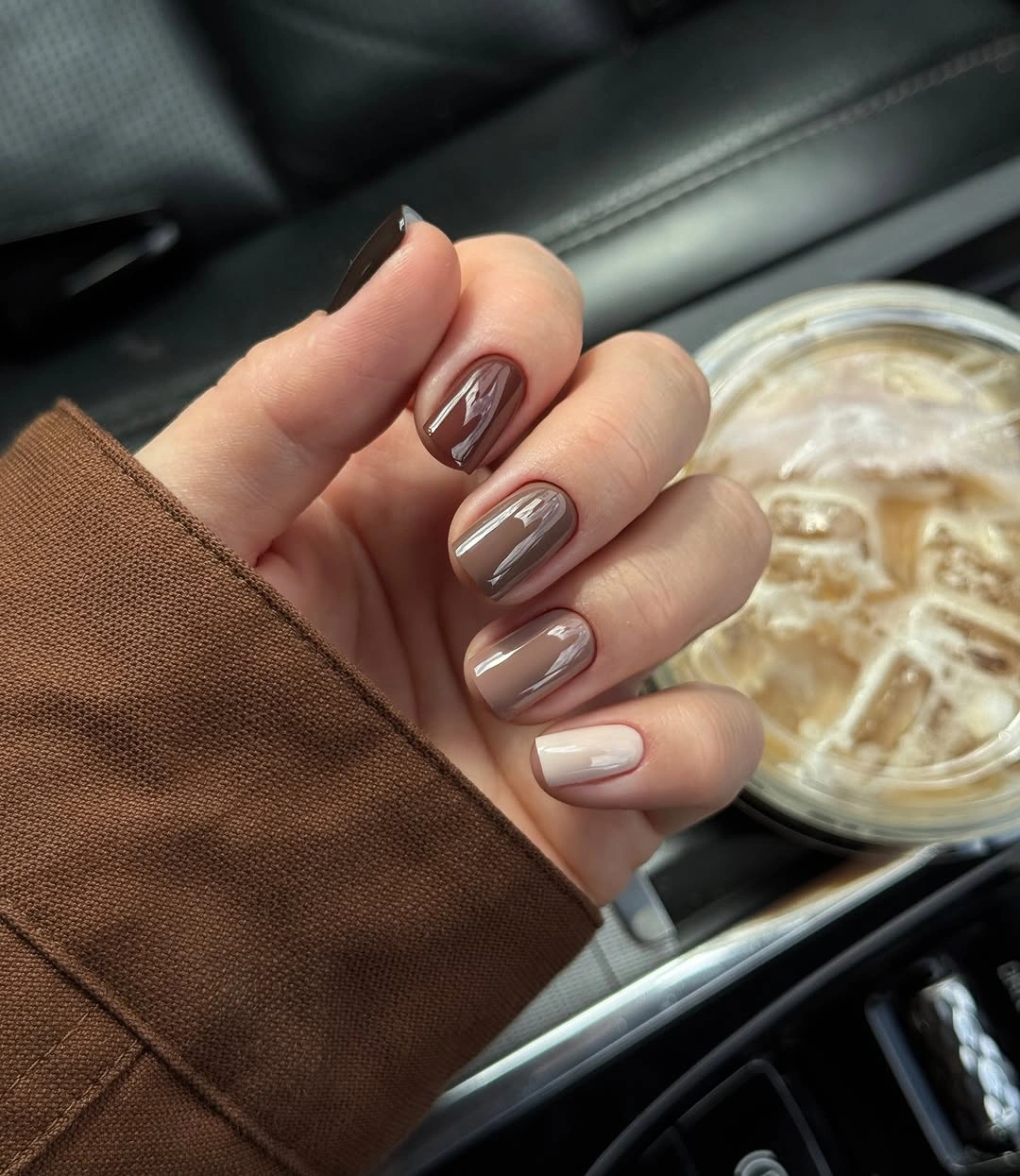 Short rounded square nails with pink bases brown edges and dots