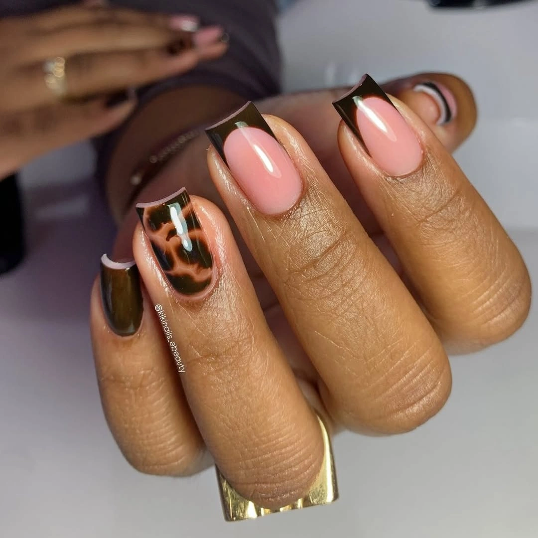 Orange square nails with white stripes and gold seasonal sparkle