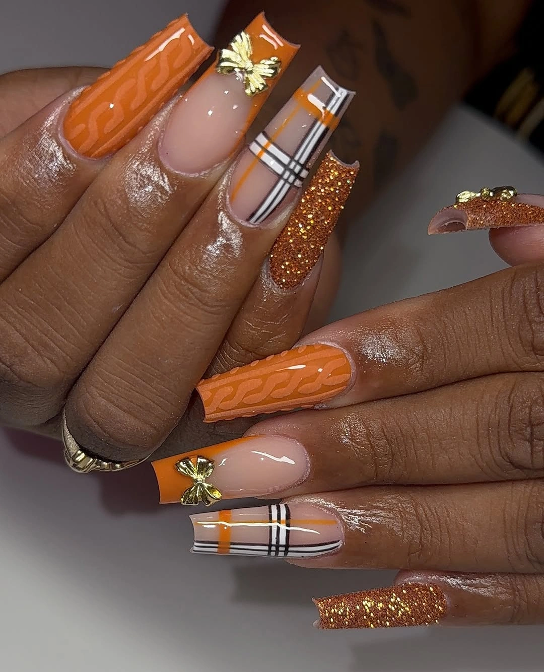 Orange nude square nails with vertical blocks and white striping