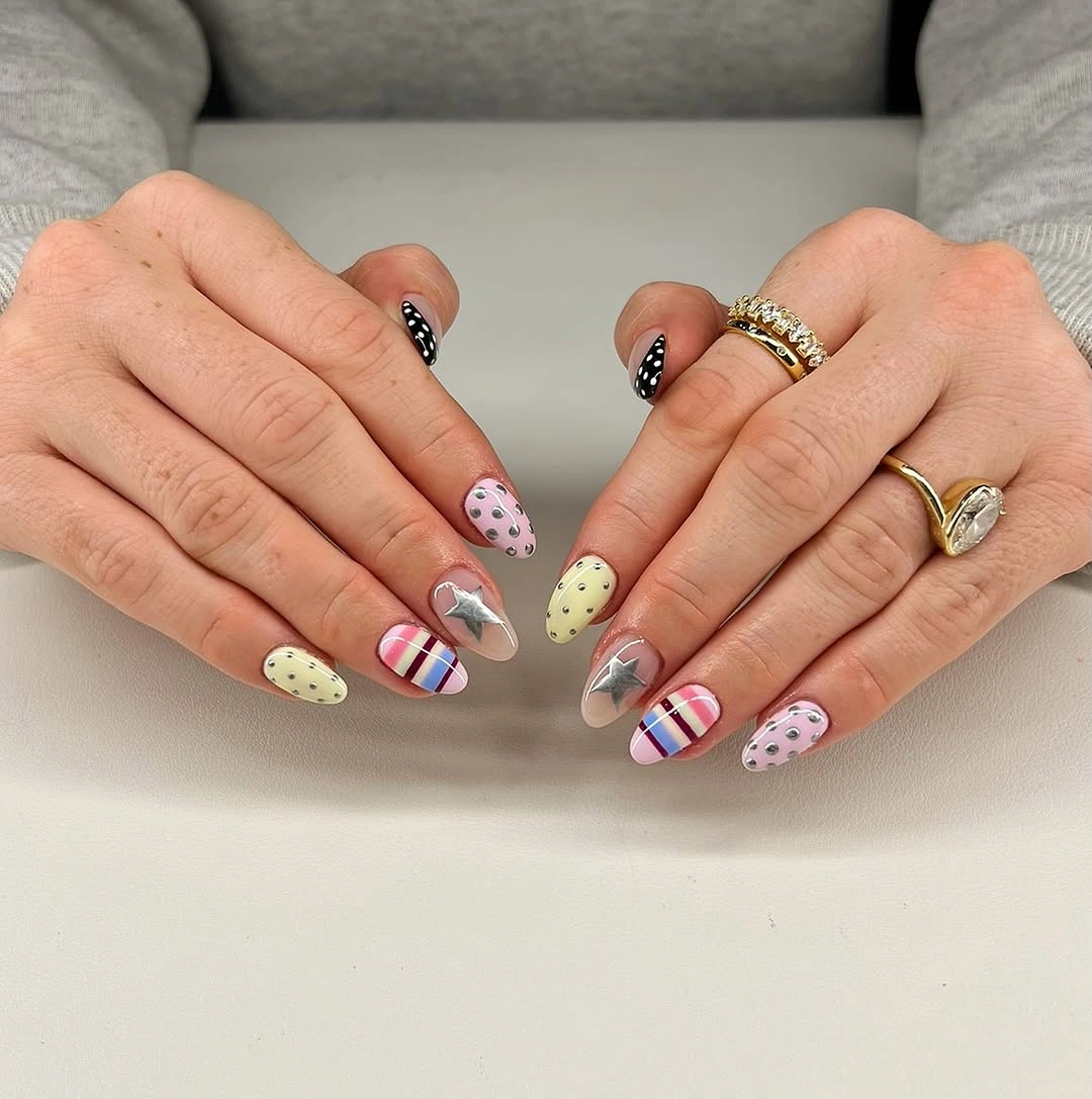 Pastel pink green yellow and blue nails with tiny striped accents