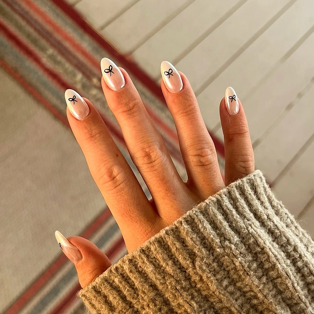 Long almond sheer nude nails with fine black French edges