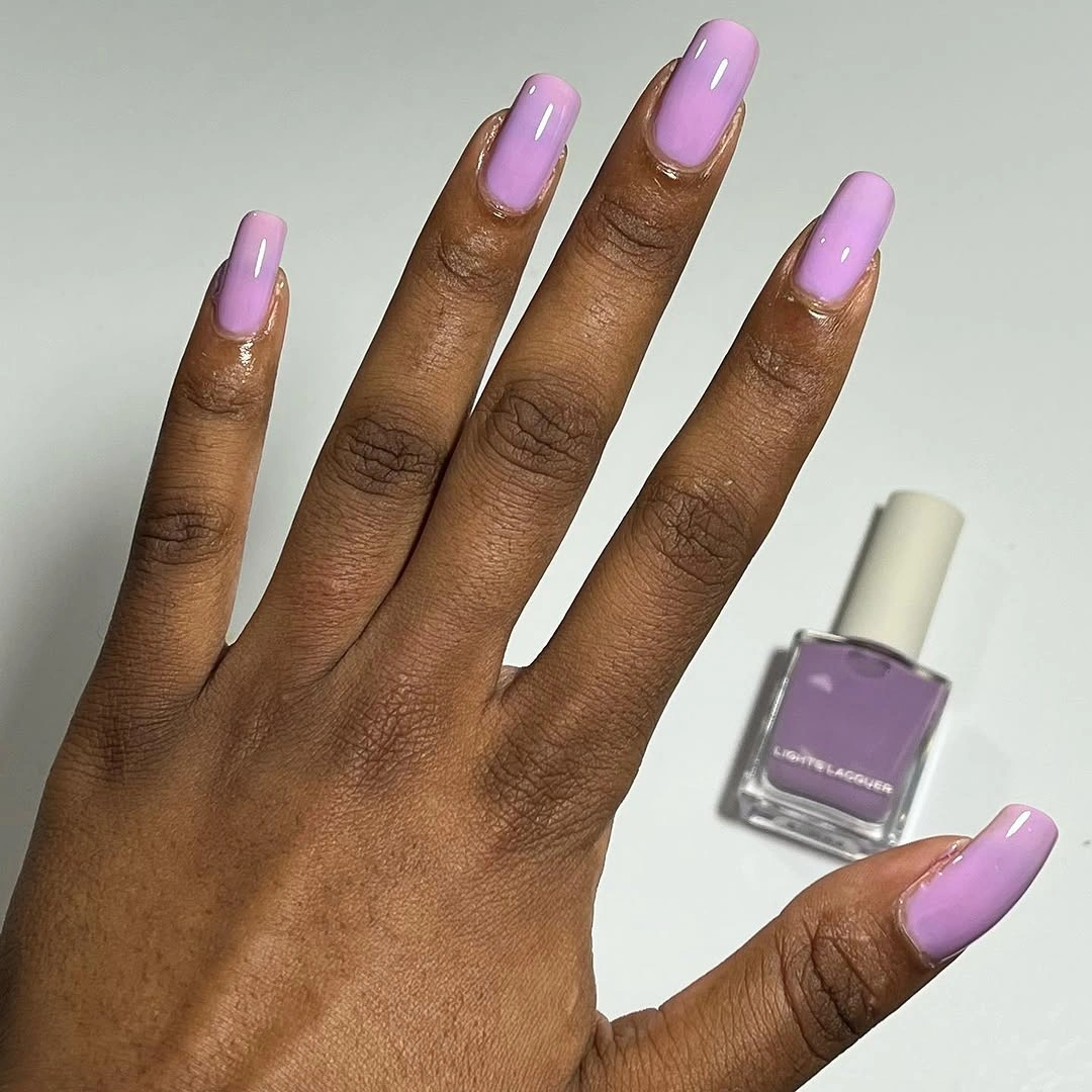 Long tapered square bright lavender fall nails on dark skin