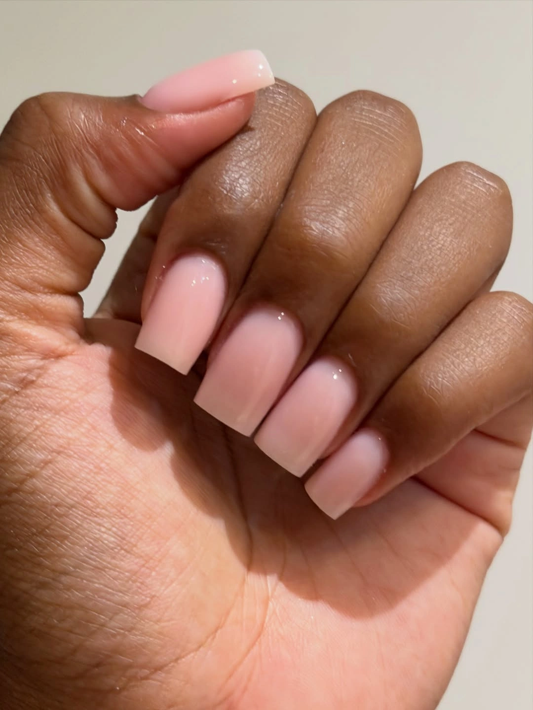 Short square pale pink fall nails on dark skin