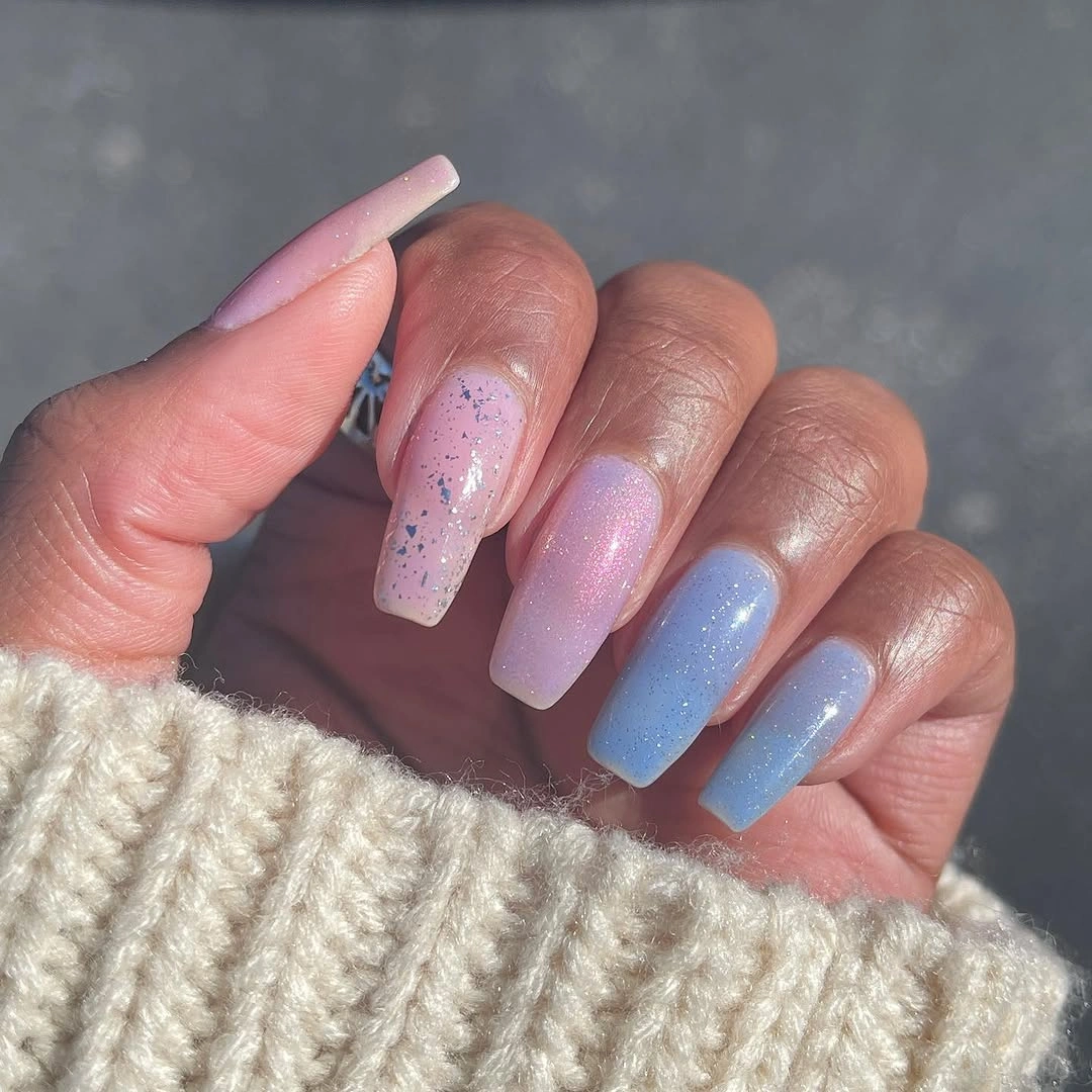 Long pastel pink and blue speckled fall nails on dark skin
