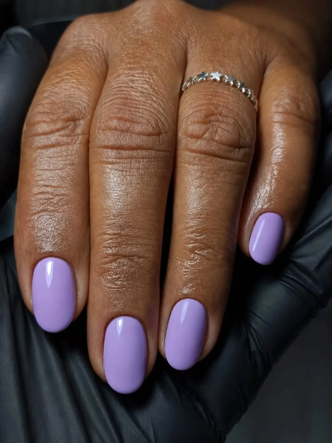 Short rounded lavender fall nails on dark skin