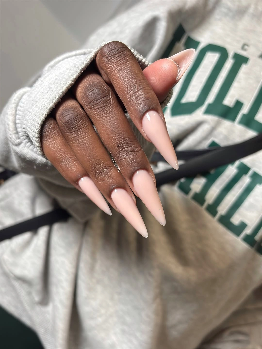 Long stiletto pale neutral fall nails on dark skin
