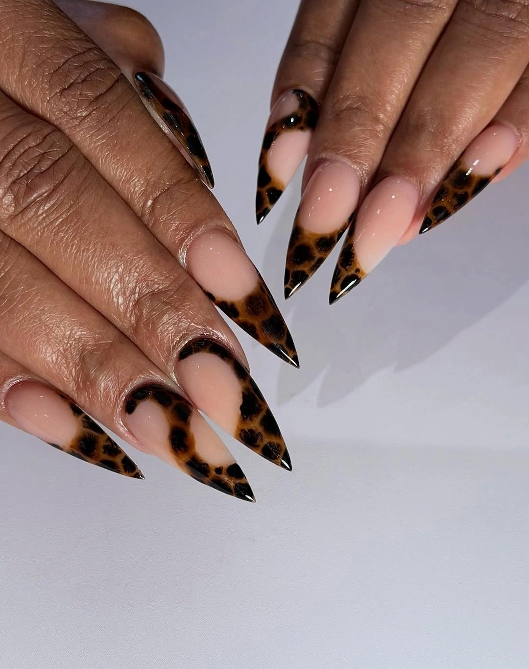 Long nude stiletto nails with brown leopard French tips