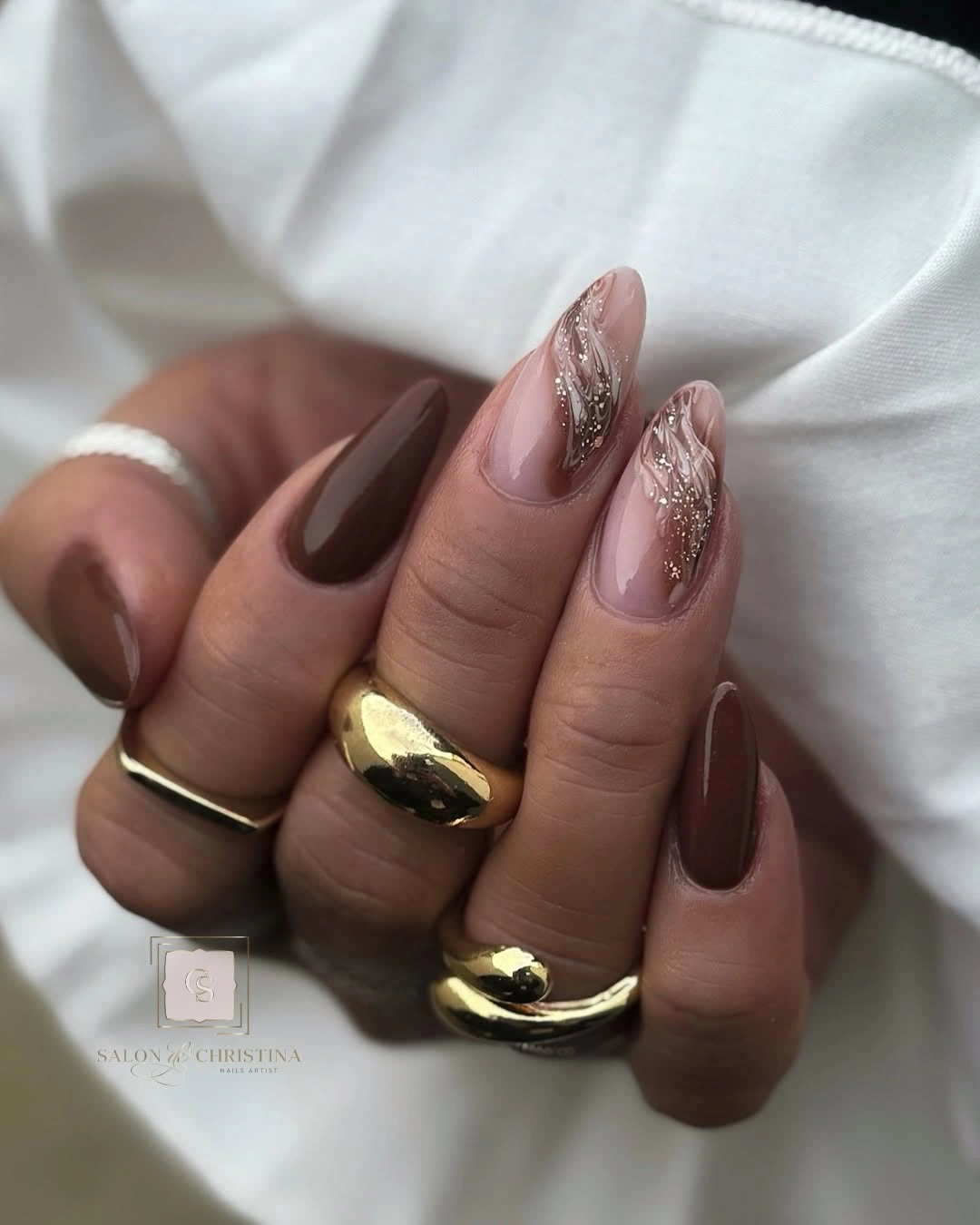 Long mauve and brown almond nails with gold accents