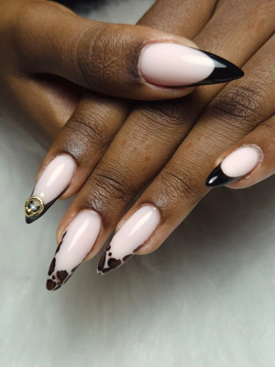 Long pale almond nails with black animal-like French tips
