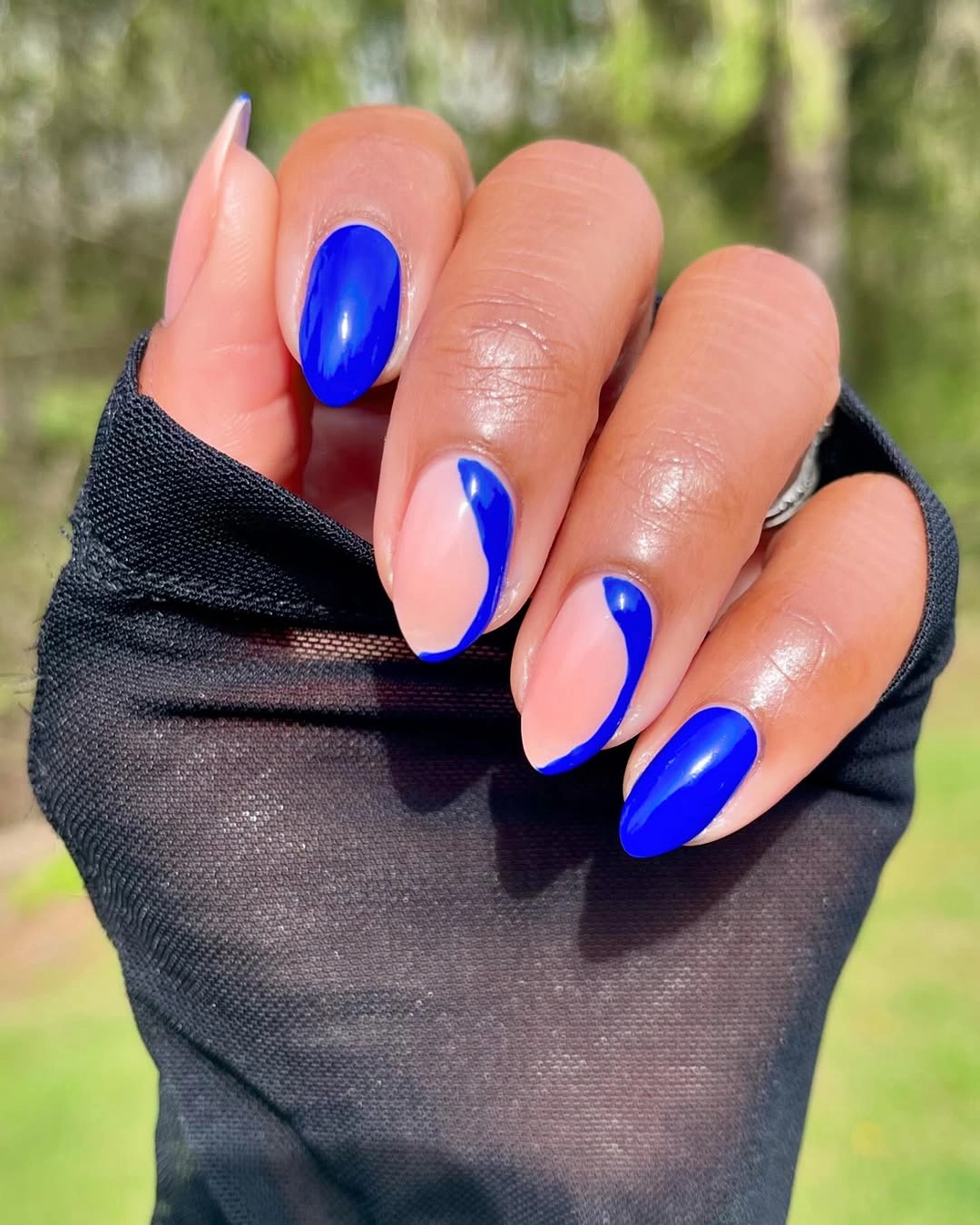 Long nude almond nails with vivid cobalt blue side accents