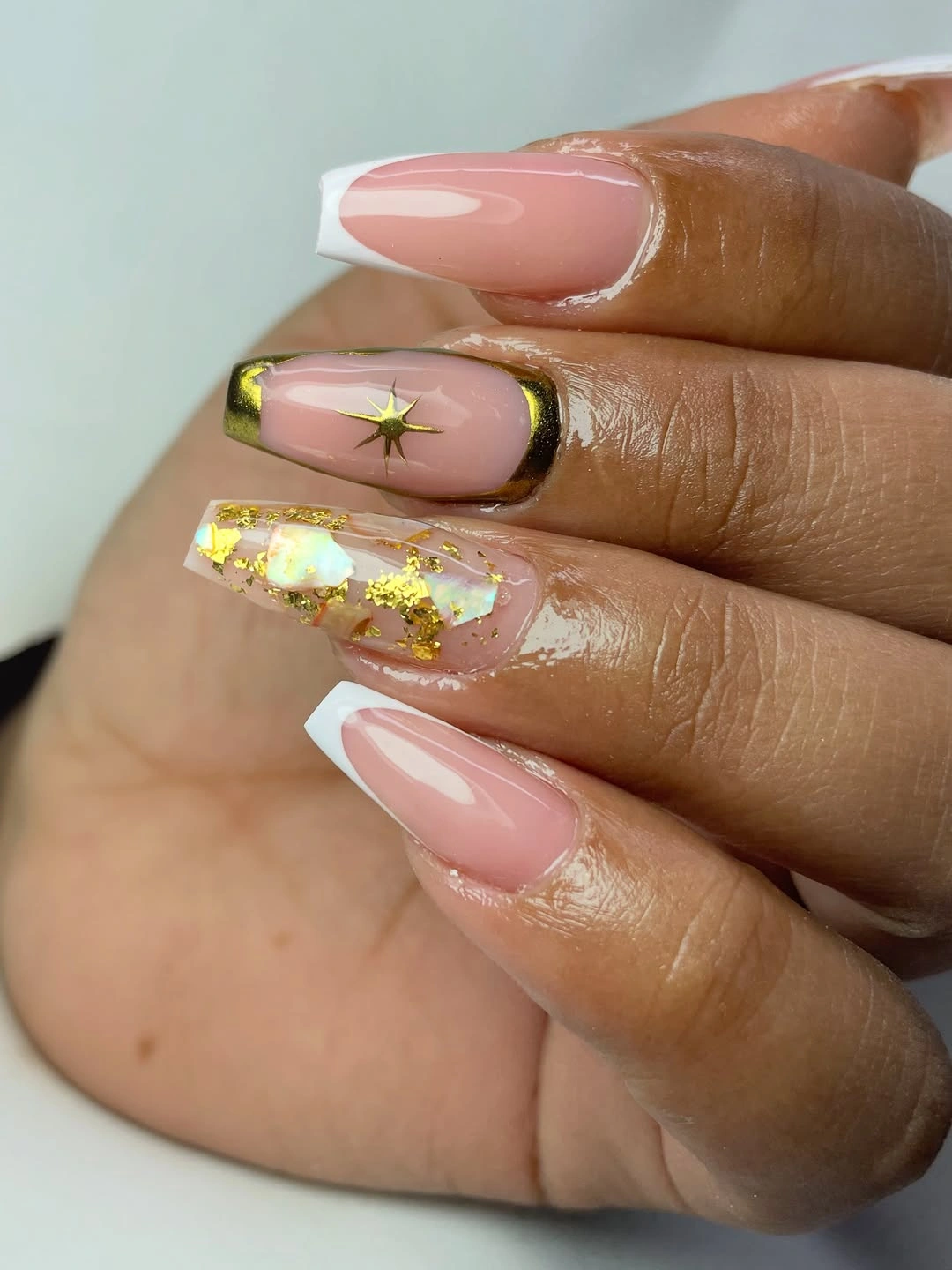Long pink nails framed with olive green and gold foil