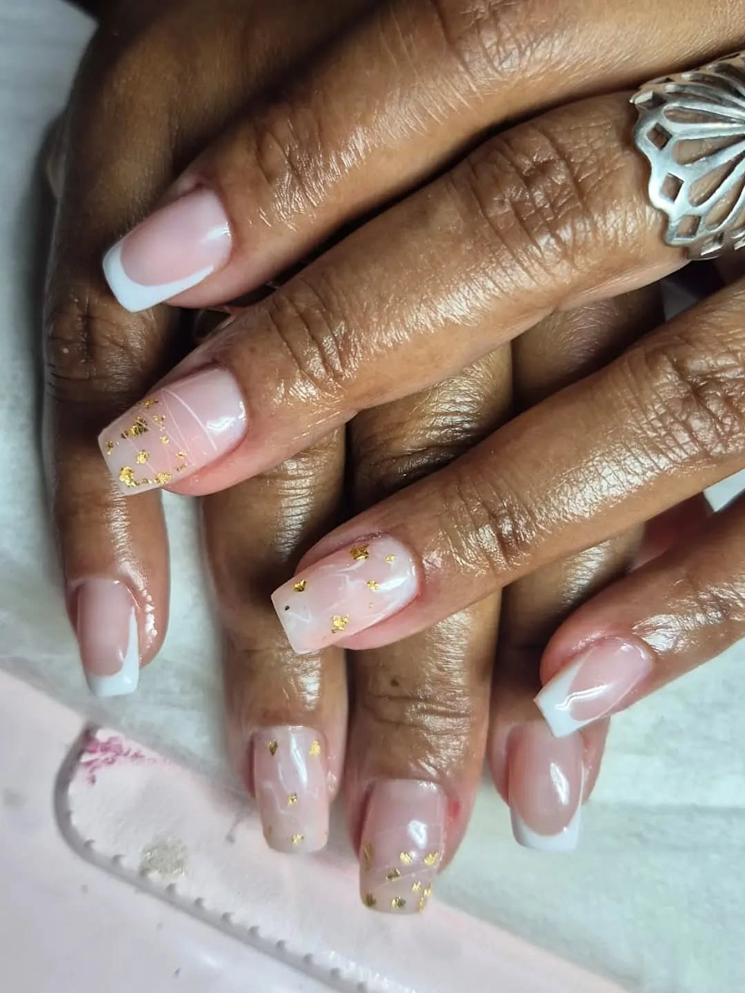 Long pale pink nails with white tips flowers and gold flakes