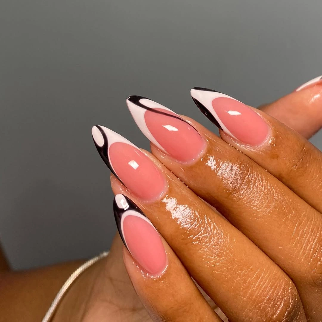 Long coral almond nails with black and white graphic edges