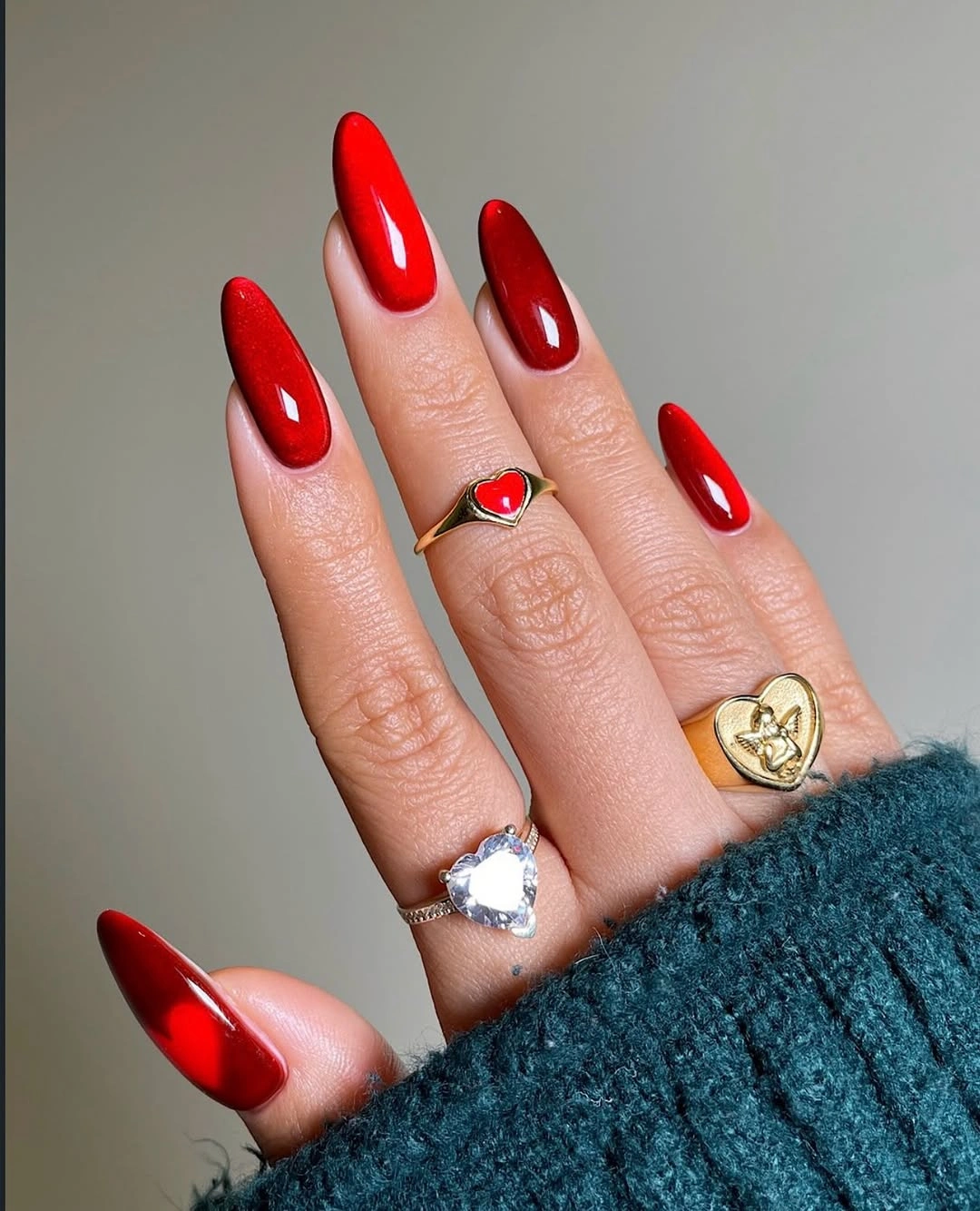 Long glossy red almond nails in a saturated fall shade