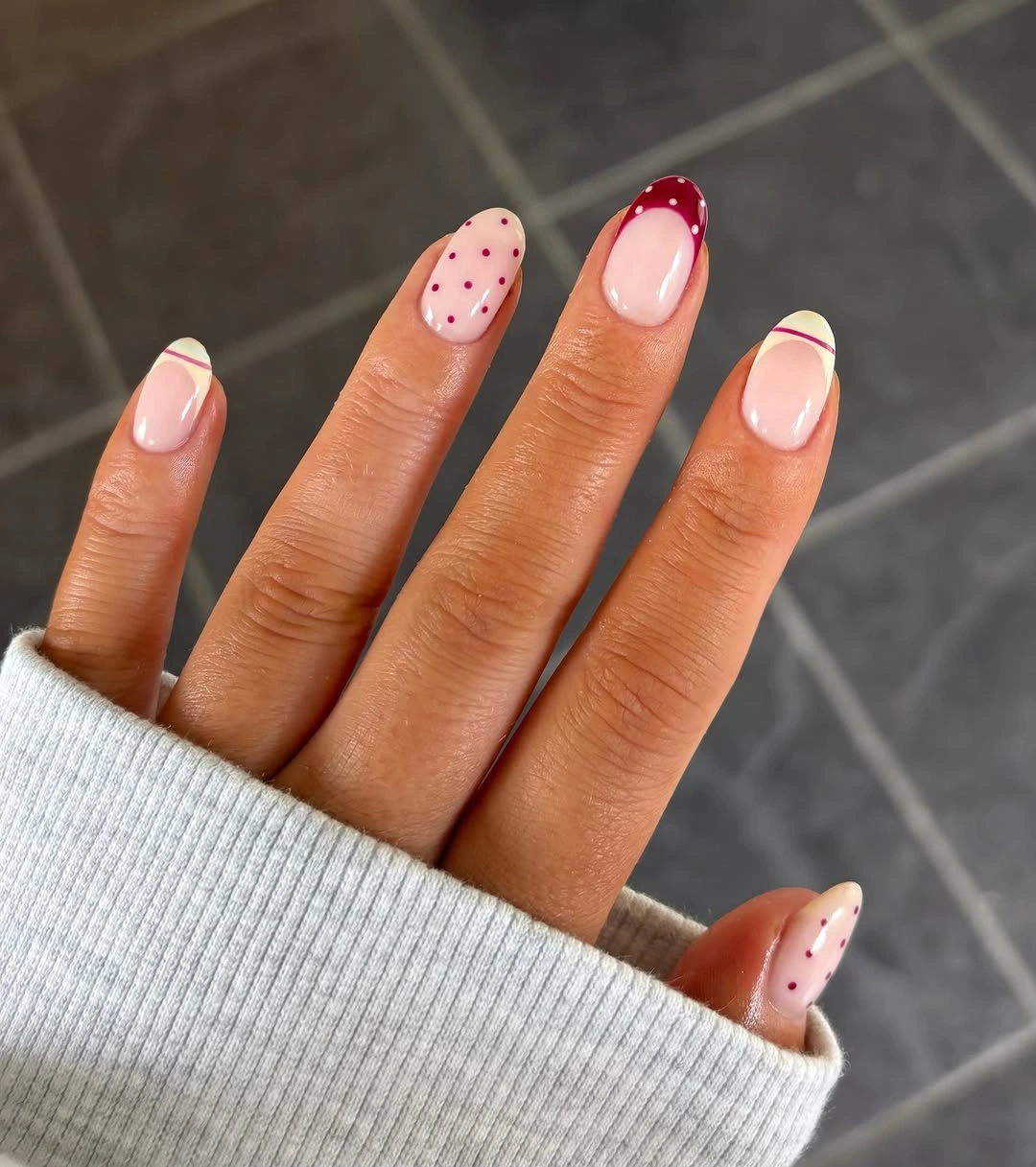 Short nude nails with sparse pink and brown autumn dots