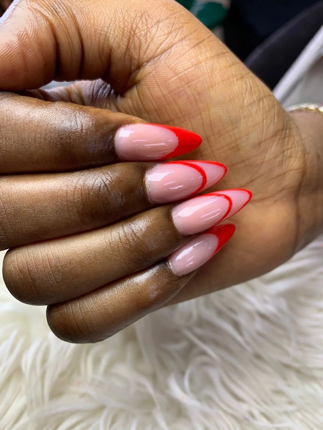 Pink almond nails with bold red outline French edges
