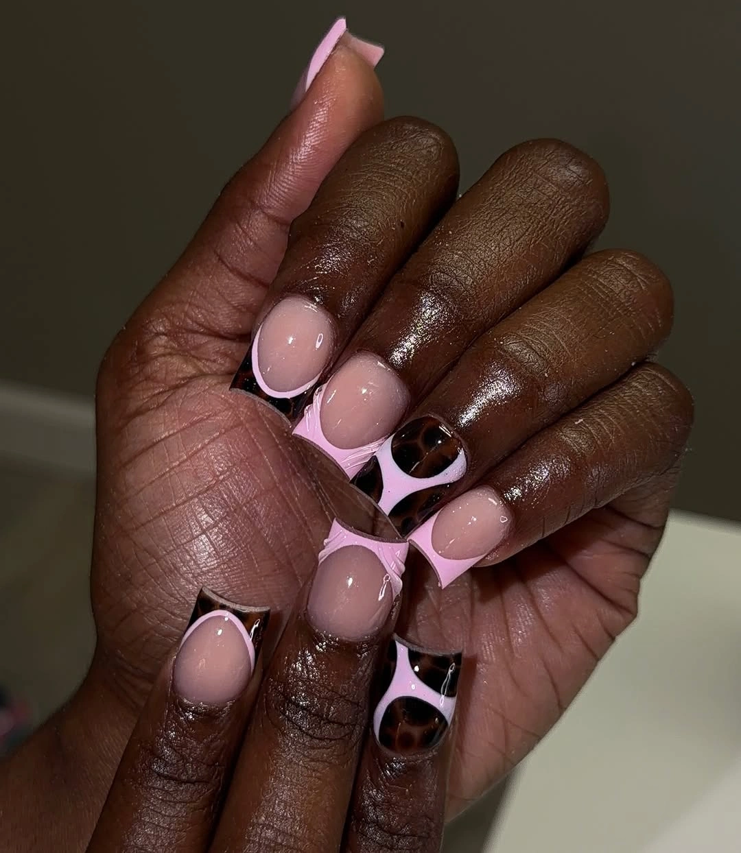 Pink black and silver long square nails with circular accents