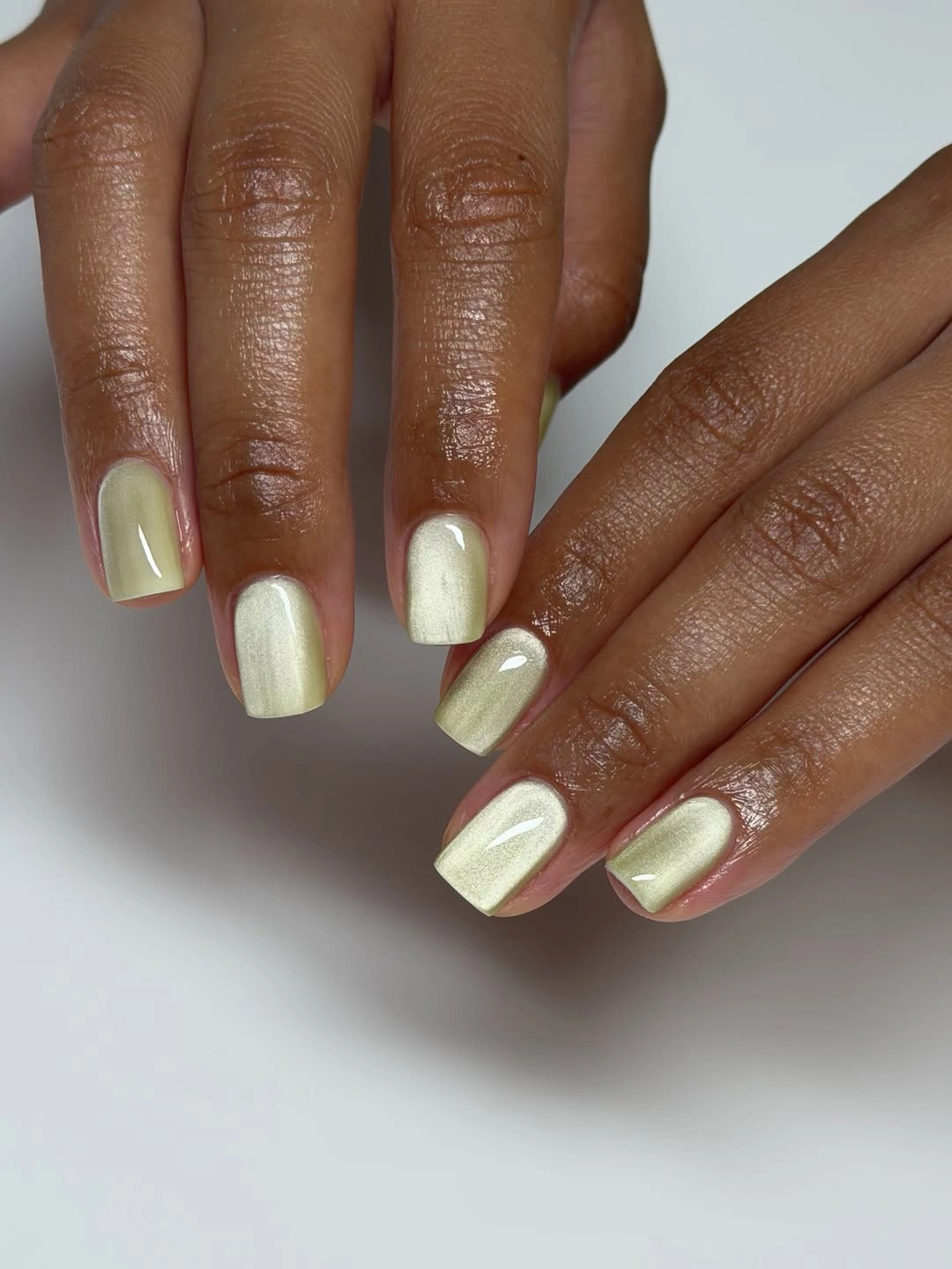 Pale yellow and ivory short square nails with glossy finish