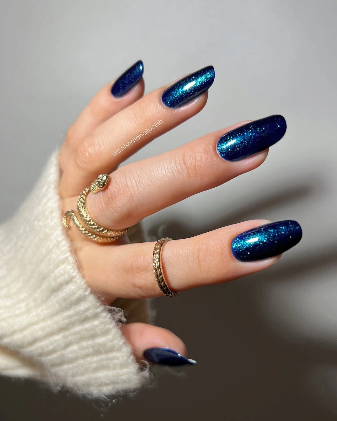 Long navy almond nails with a narrow reflective highlight