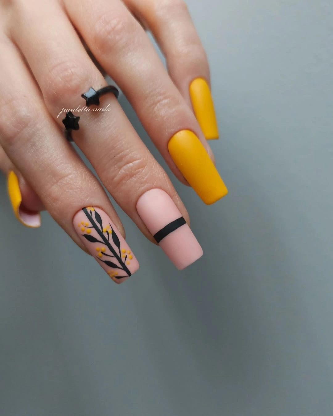 Long coffin nails in mustard pink black and floral accents