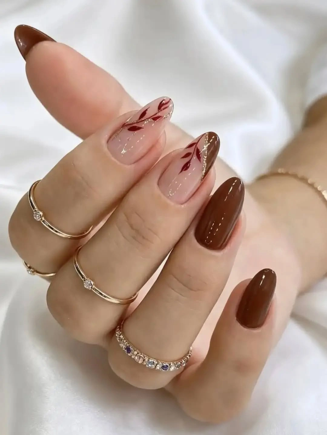 Medium almond chocolate nails with one fine brown curve