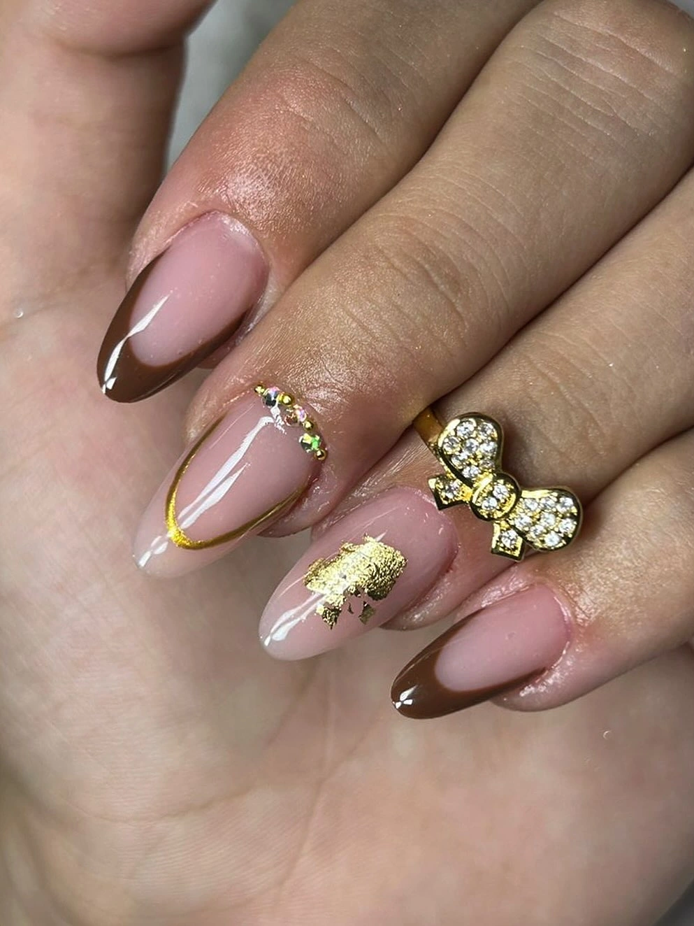 Long pink nude almond nails with brown double French tips