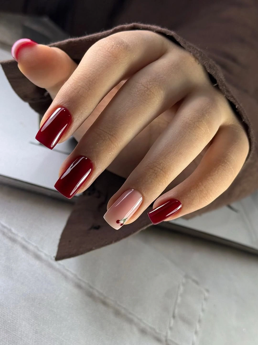 Long square burgundy red and nude nails with tiny accents
