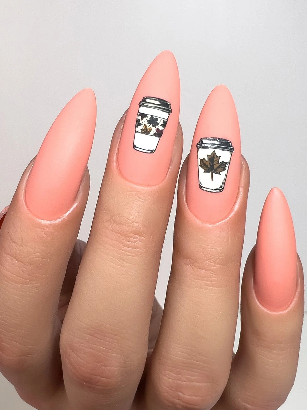 Long matte coral almond nails with black white panels