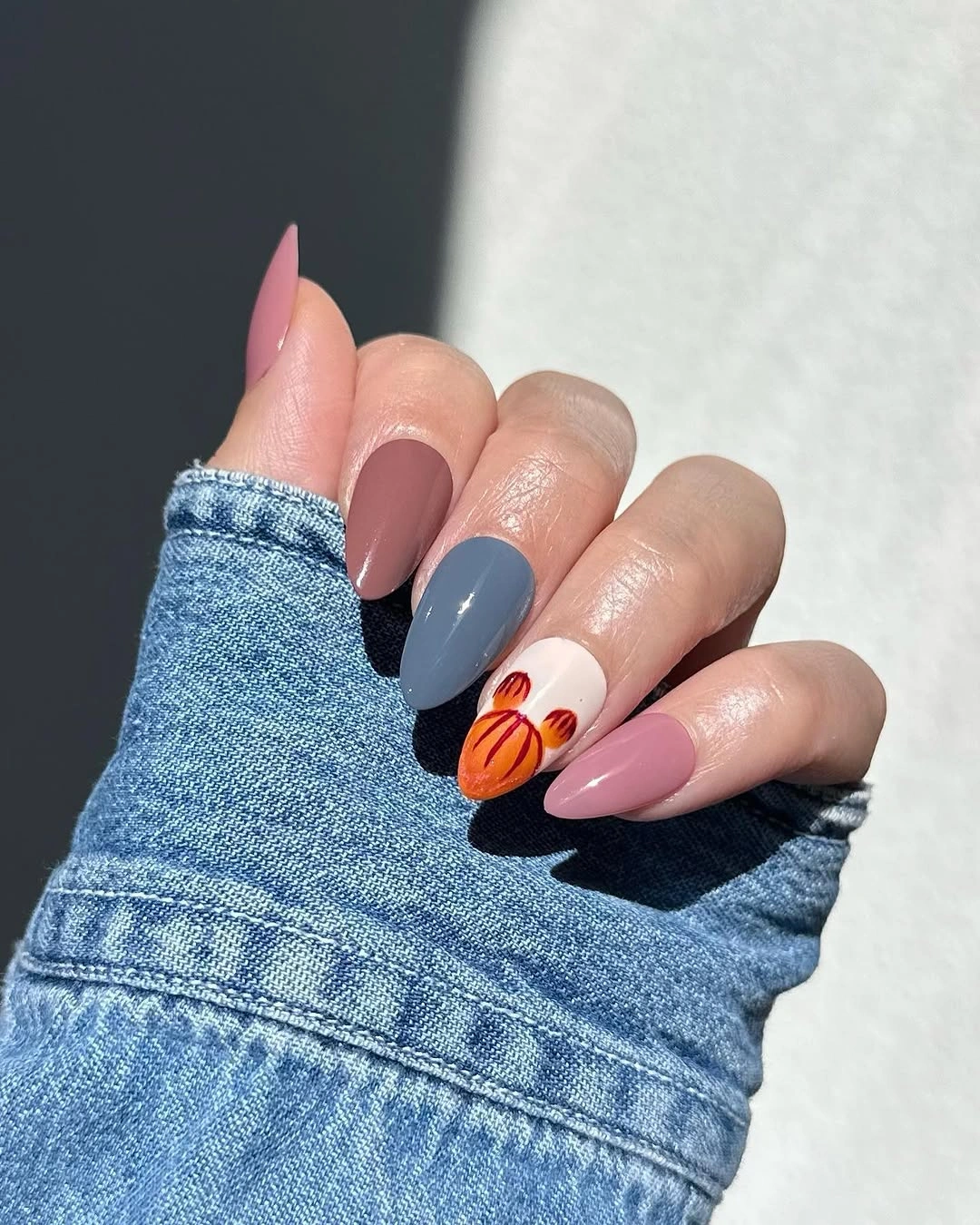 Long pink and slate blue almond nails with orange accent art
