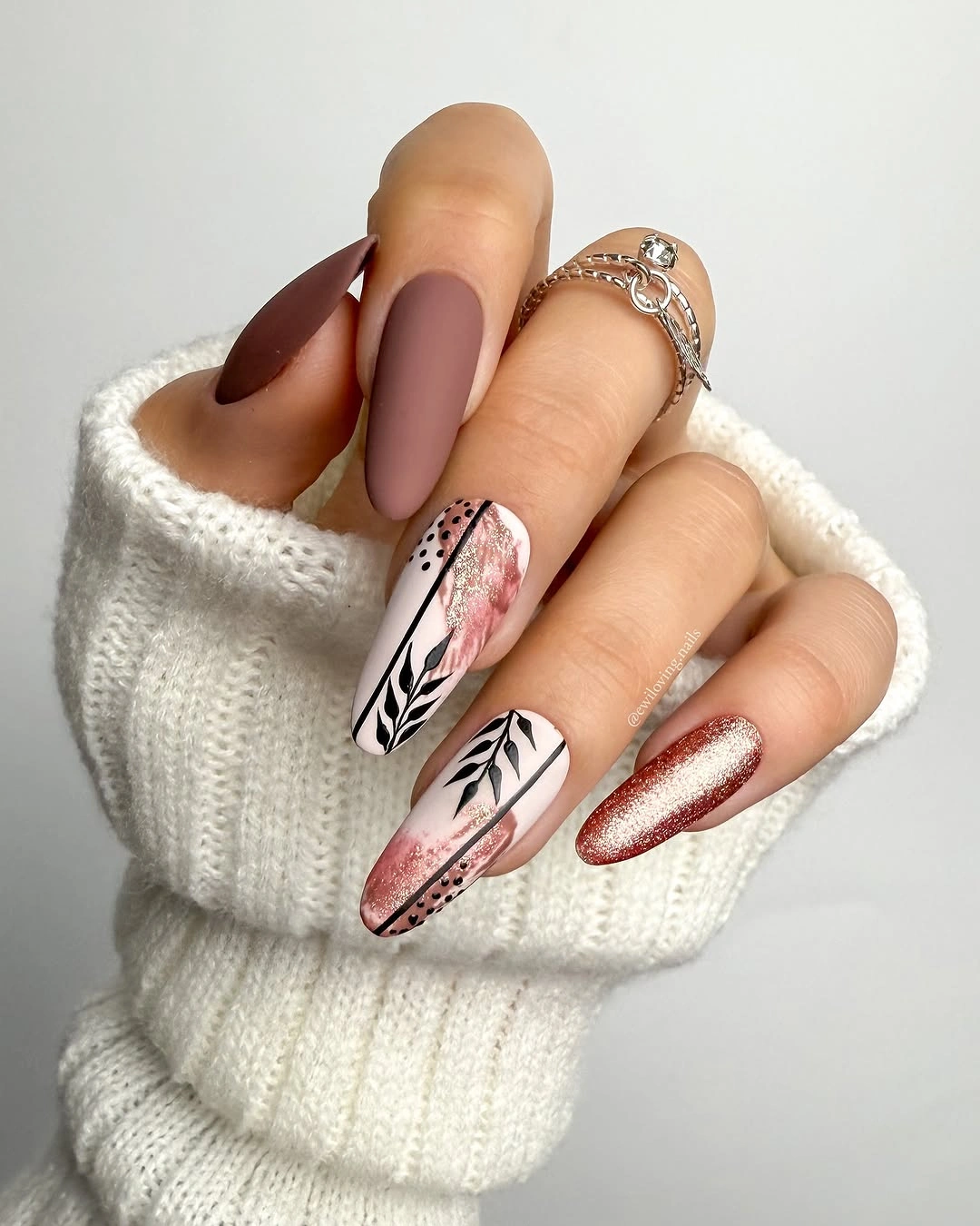 Taupe burgundy almond nails with fine botanical line accents