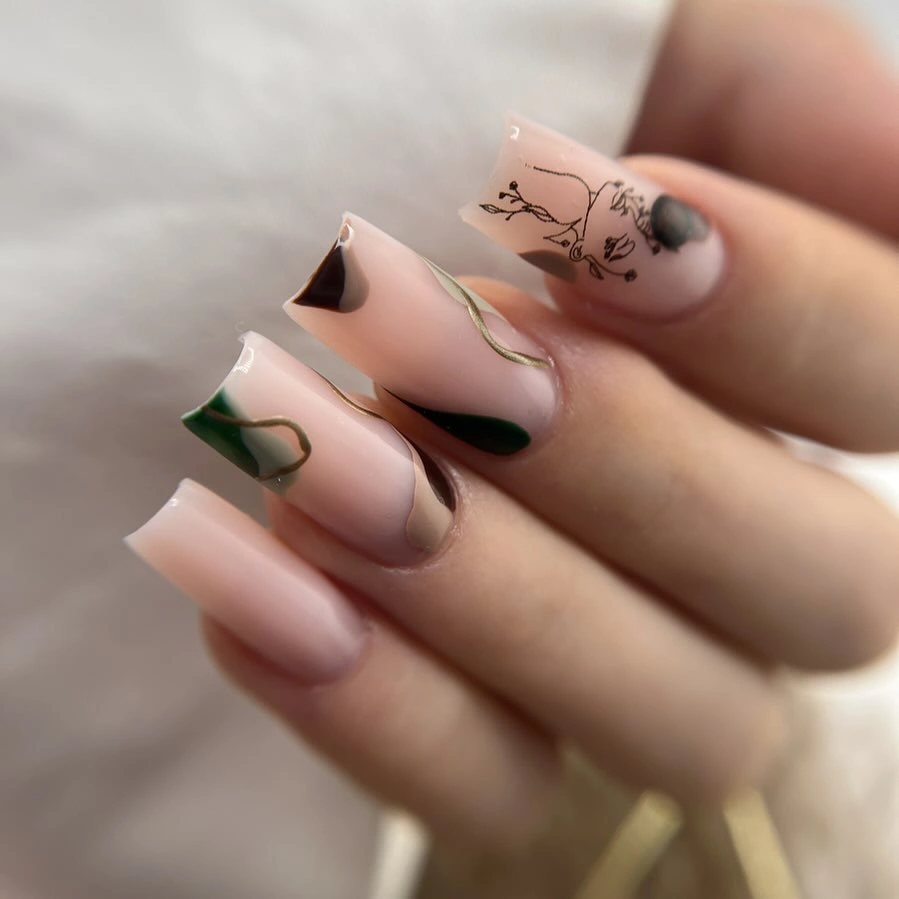 Nude nails with black and deep green angular tips