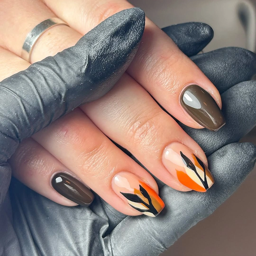 Short almond brown orange cream nails with flame curves