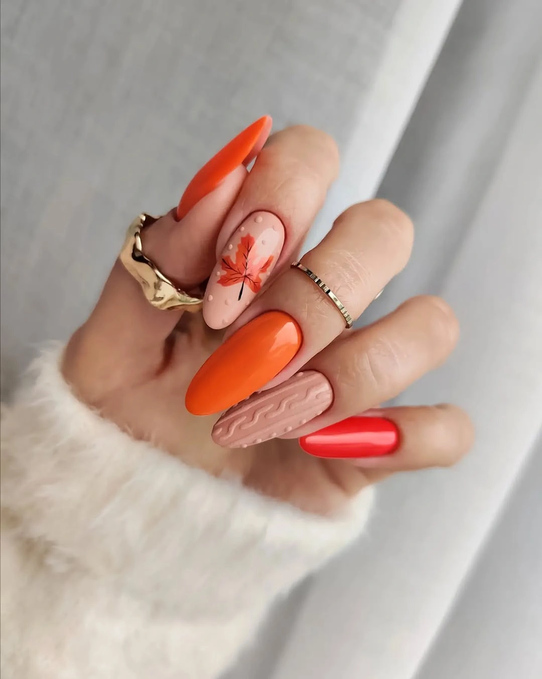 Long orange red nude nails with warm beige accent