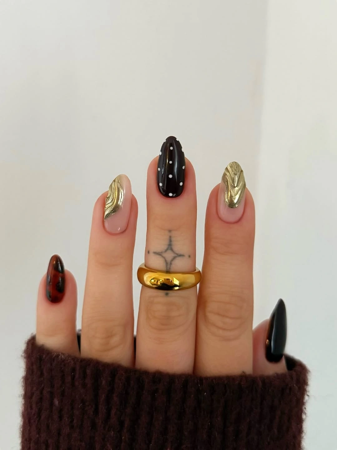 Long pointed black gold and deep red graphic nails