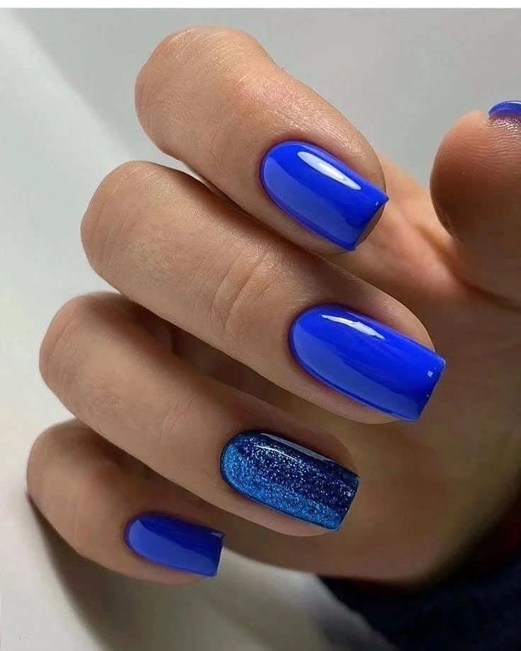 Medium coffin cobalt nails with one deeper blue sparkling accent