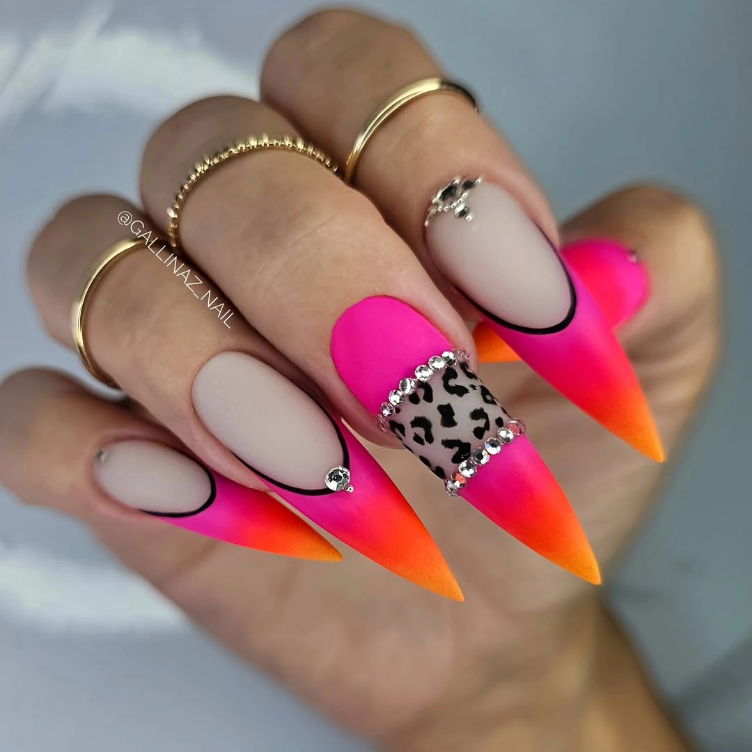 Long stiletto neon tips with one dark spotted accent