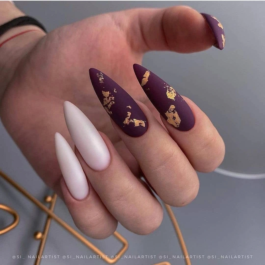 Long plum and blush nails with delicate warm metallic-looking flecks